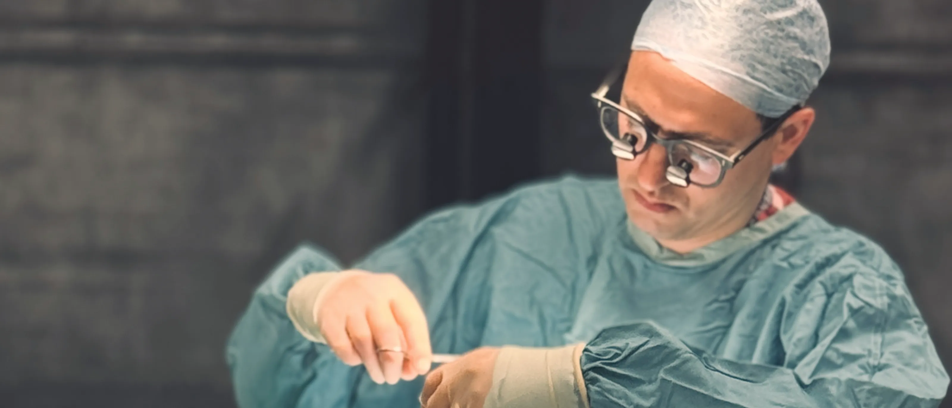 Close up view of Mr. Schulz suturing in theatre.